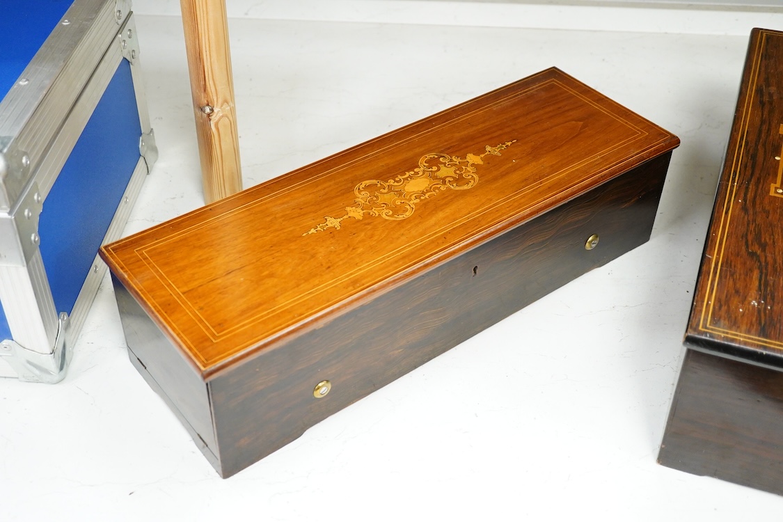 A 19th century Swiss cylinder music box by Nicole Freres, Geneve, key wound movement (with key present) playing six airs, in an inlaid rosewood case, cylinder 33cm long, the case; 52cm long, 13cm high, 17.5cm deep